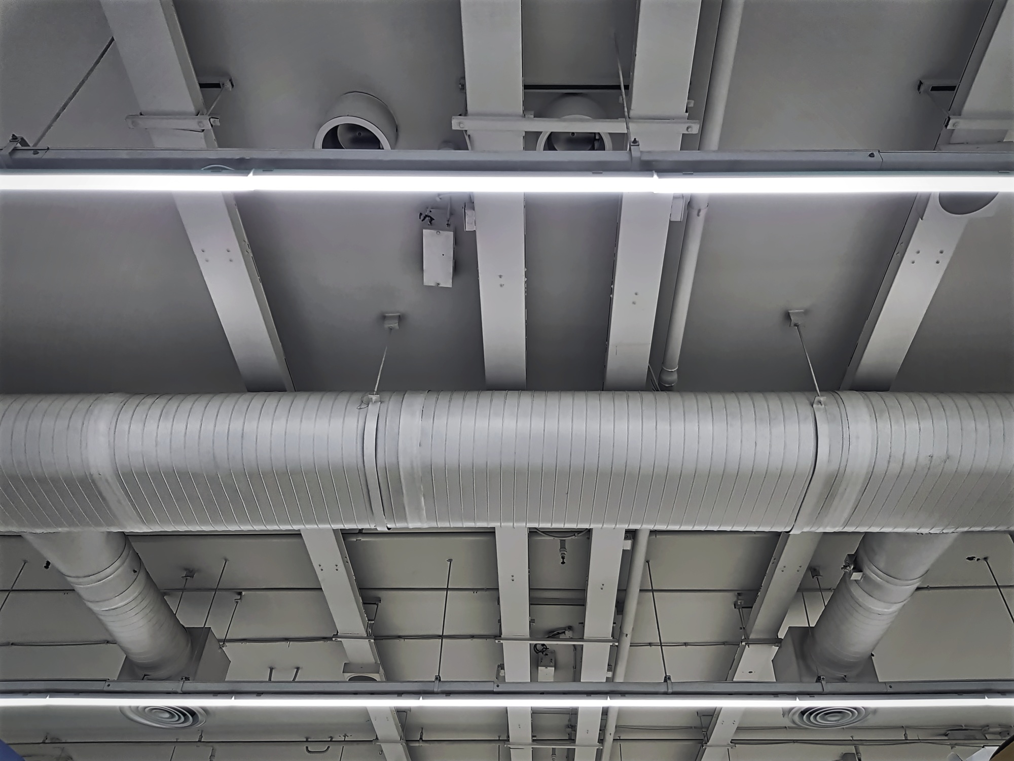 Low Angle View of Air Conditioning Ducts and Piping with Illumination